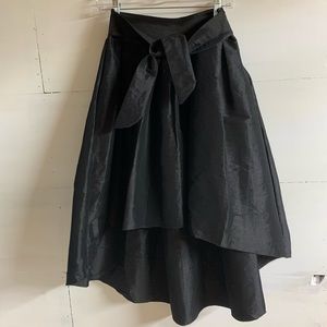 Black skirt. CeCe high low tie front